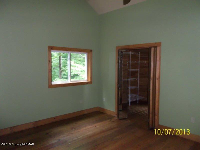 130 Donaldson Road Cresco, PA 18326 - Photo 8 of 20 an empty room with wooden floor and windows