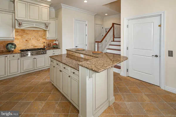 a kitchen with stainless steel appliances granite countertop a sink and cabinets