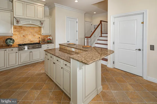 a kitchen with stainless steel appliances granite countertop a sink and cabinets