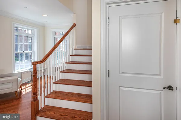 a view of staircase with wooden floor and a window