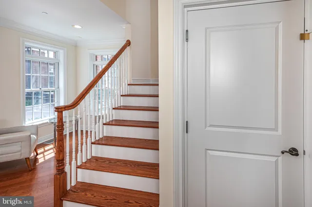 a view of staircase with wooden floor and a window
