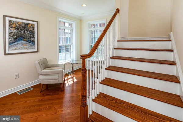 a living room with wooden floor and a rug