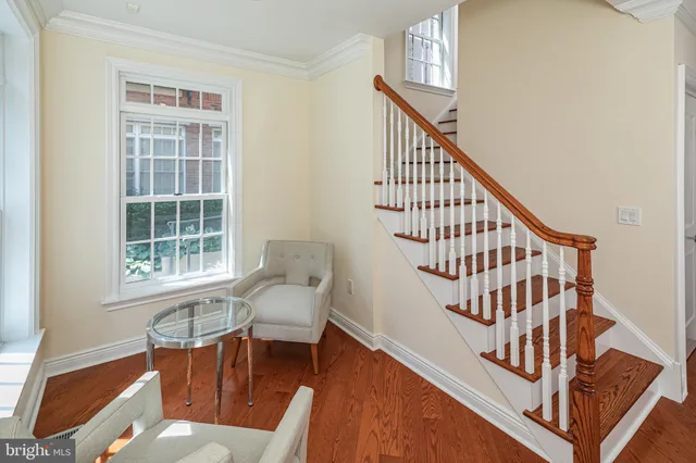 a view of staircase with furniture and a window