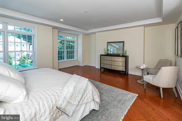 a bedroom with a bed and a chair