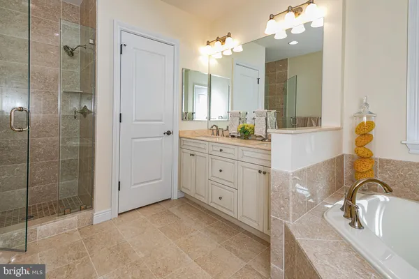 a spacious bathroom with a granite countertop sink and a mirror
