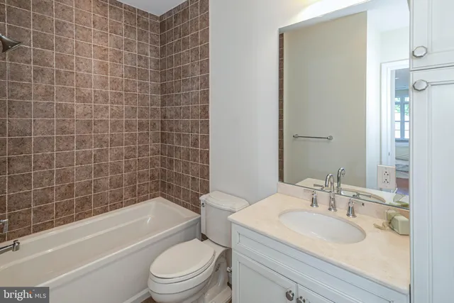 a bathroom with a sink toilet vanity and bathtub