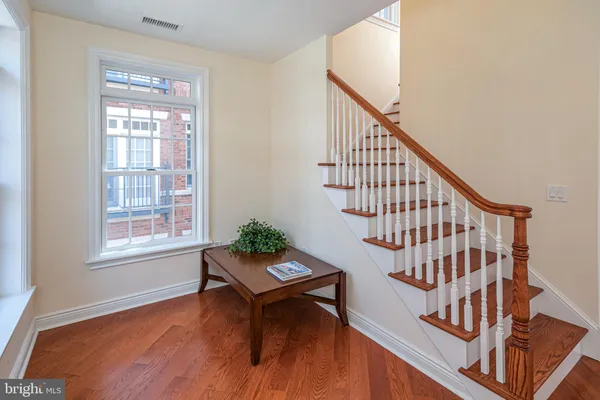 a living room with wooden floor and a window
