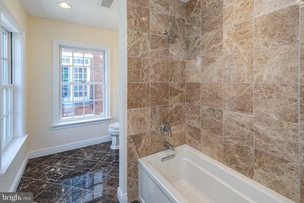 a bathroom with a bathtub and shower