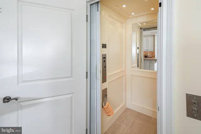 a view of a hallway with closet and bathroom