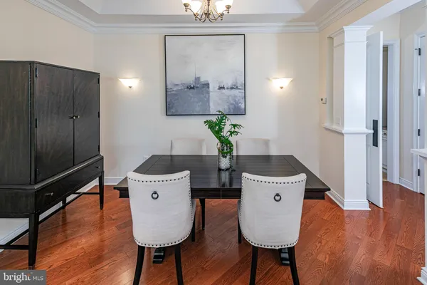 a dining room with furniture and wooden floor