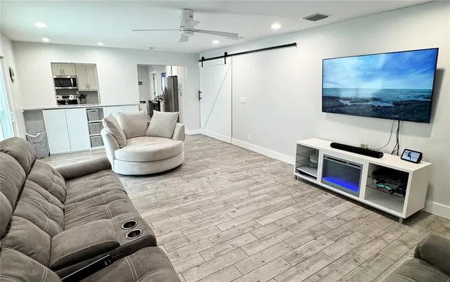 a living room with furniture and a flat screen tv
