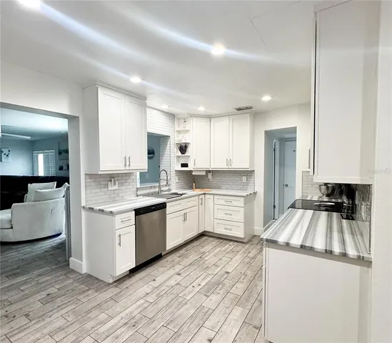 a kitchen with a stove top oven sink and cabinets