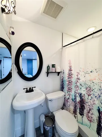 a bedroom with a bed window and flat screen tv