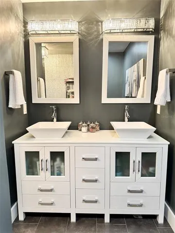 a bedroom with a bed a mirror and a window