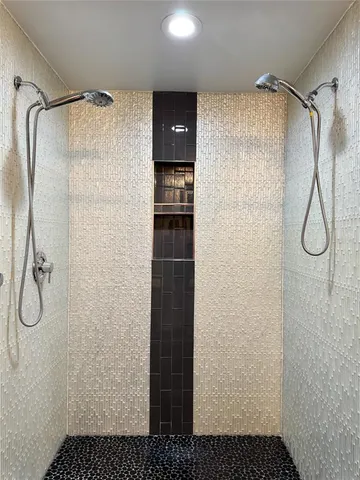 a bathroom with a bathtub and shower