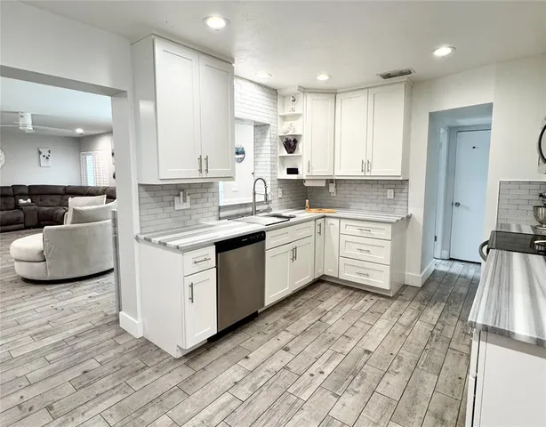 a view of a kitchen with a sink and cabinets