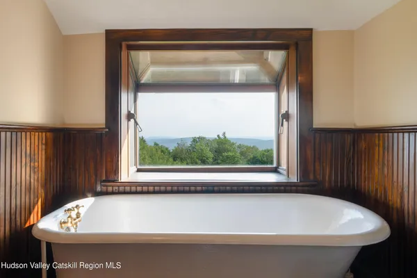 a room with a bed and wooden floor