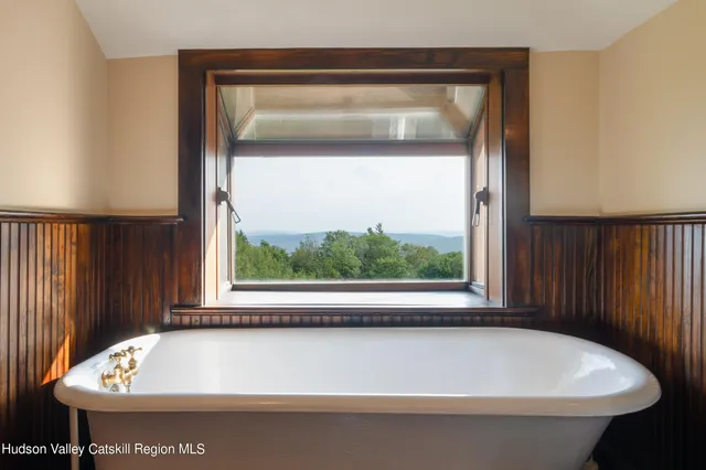 a room with a bed and wooden floor