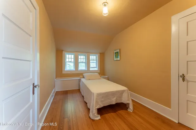 a bedroom with a large bed and a window