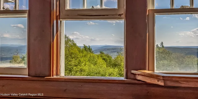 a view of a dining room with furniture water view and wooden floor