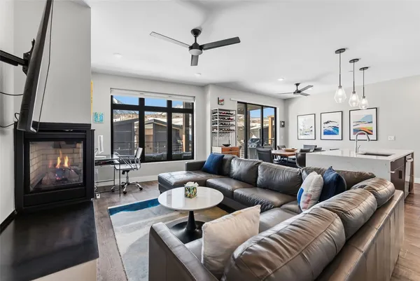 a living room with furniture a fireplace and a flat screen tv