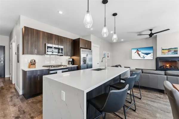 a kitchen with a dining table cabinets appliances and a counter top space