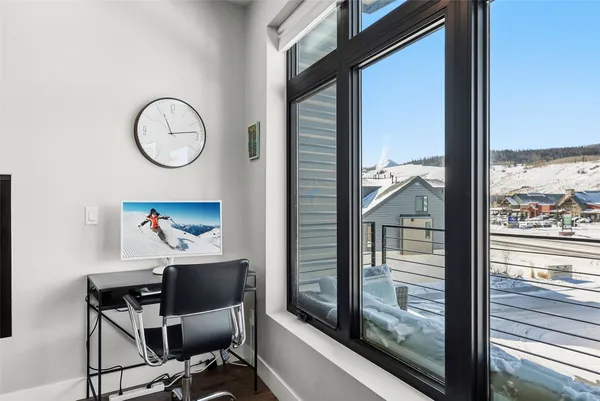 a view of a hallway with furniture and front door