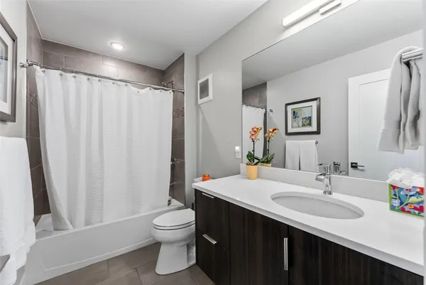 a bathroom with a double vanity sink toilet and a mirror
