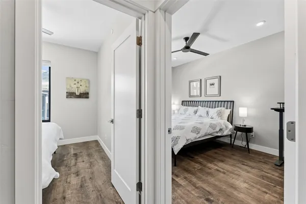 a view of a bedroom with a bed and wooden floor