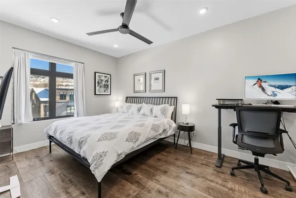 a bedroom with a bed a desk and chair