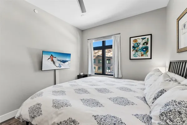 a bedroom with a bed and a window