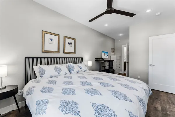 a bedroom with a large bed and a chandelier