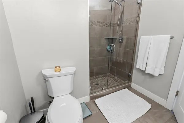 a white toilet sitting next to a bathroom sink