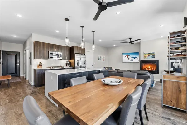 a large kitchen with kitchen island a dining table and chairs