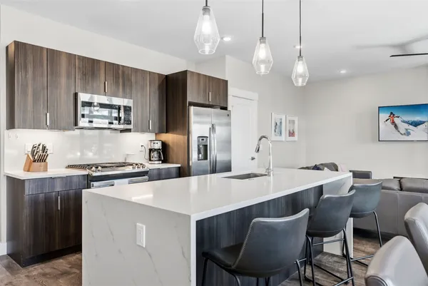 a kitchen with a dining table and chairs