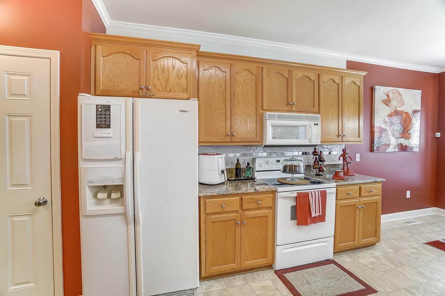 306 Wendover Drive Locust, NC 28097 - Photo 13 of 42 a kitchen with stainless steel appliances granite countertop a refrigerator and a stove top oven