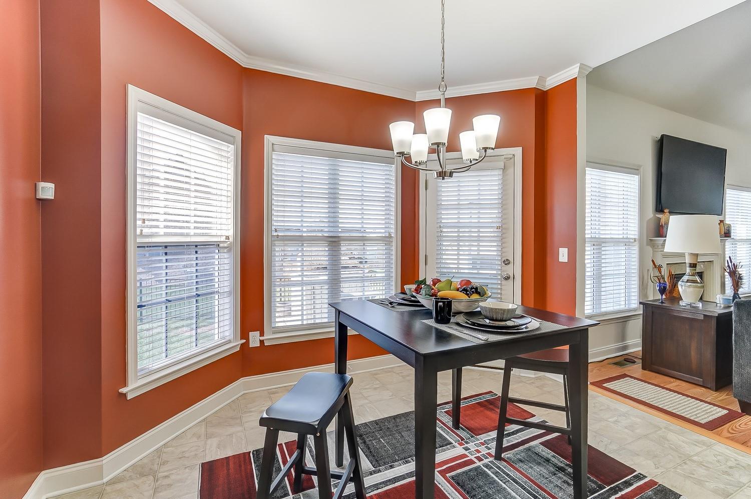 306 Wendover Drive Locust, NC 28097 - Photo 14 of 42 a dining room with furniture a chandelier and wooden floor