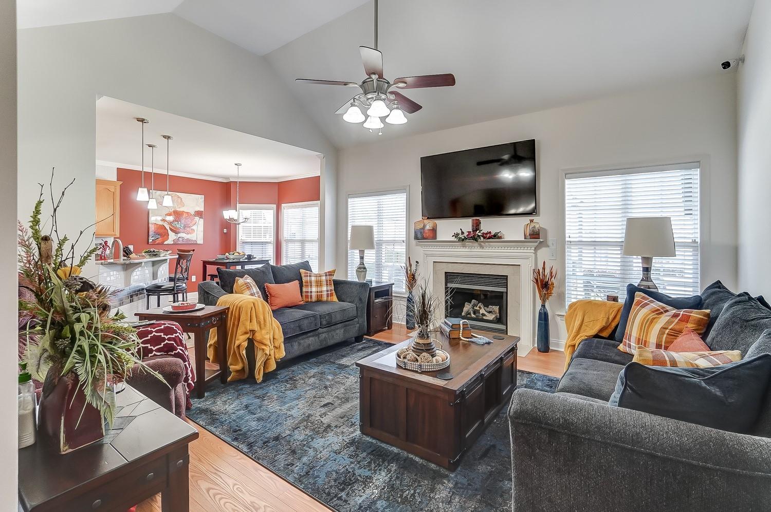 306 Wendover Drive Locust, NC 28097 - Photo 17 of 42 a living room with furniture a flat screen tv and a fireplace