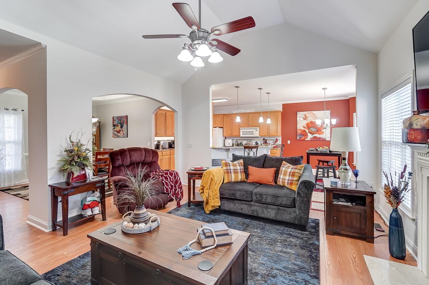 306 Wendover Drive Locust, NC 28097 - Photo 18 of 42 a living room with furniture a chandelier and a flat screen tv