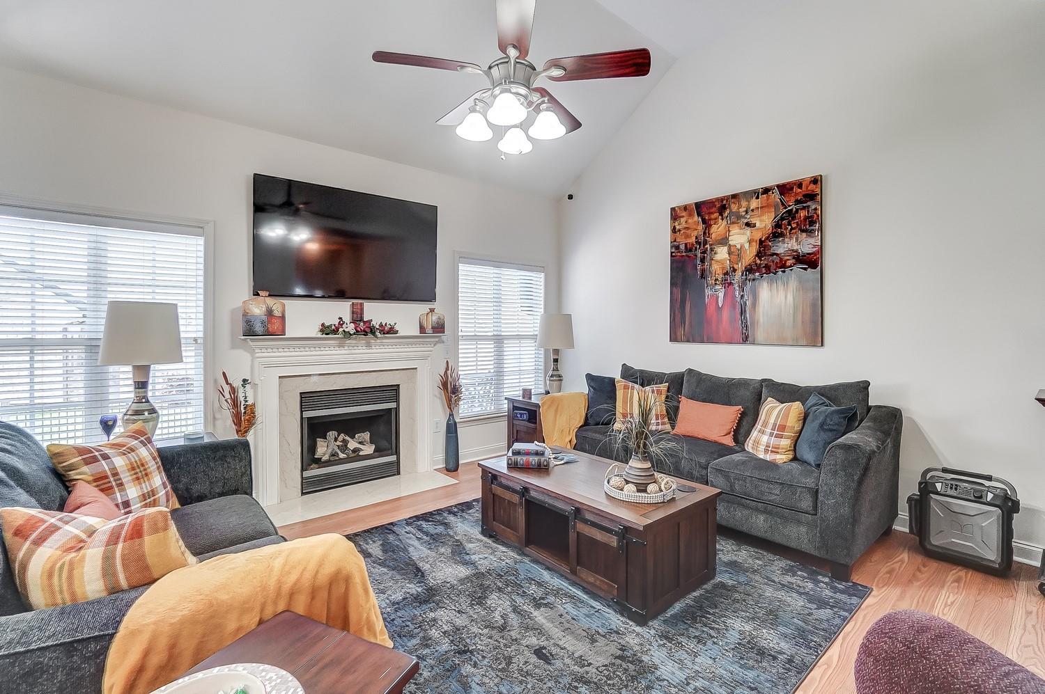 306 Wendover Drive Locust, NC 28097 - Photo 19 of 42 a living room with furniture a flat screen tv and a fireplace