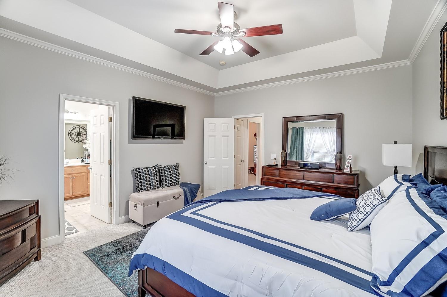 306 Wendover Drive Locust, NC 28097 - Photo 25 of 42 a bedroom with a bed and a flat screen tv