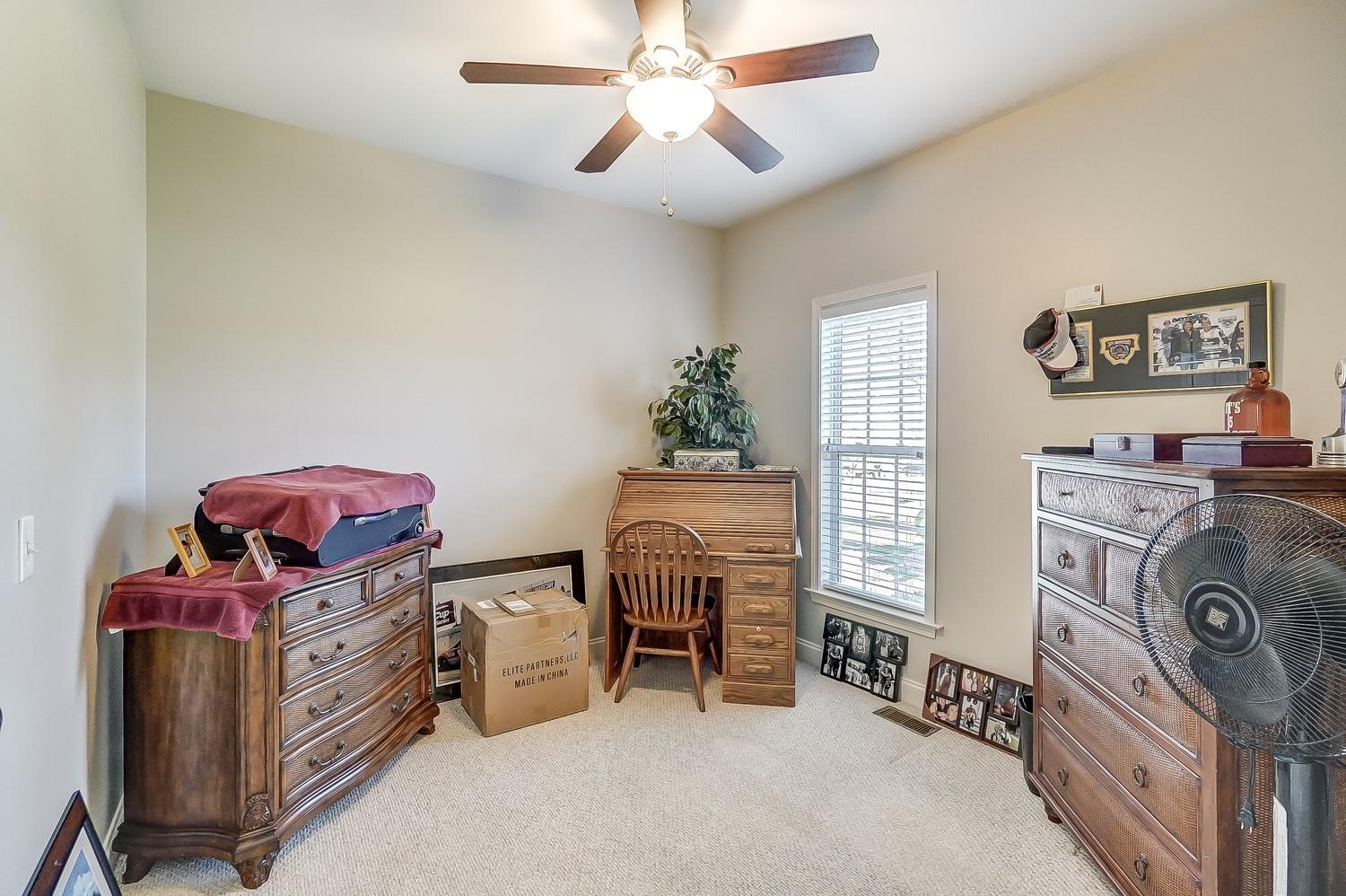 306 Wendover Drive Locust, NC 28097 - Photo 29 of 42 a bedroom with a bed and a chandelier