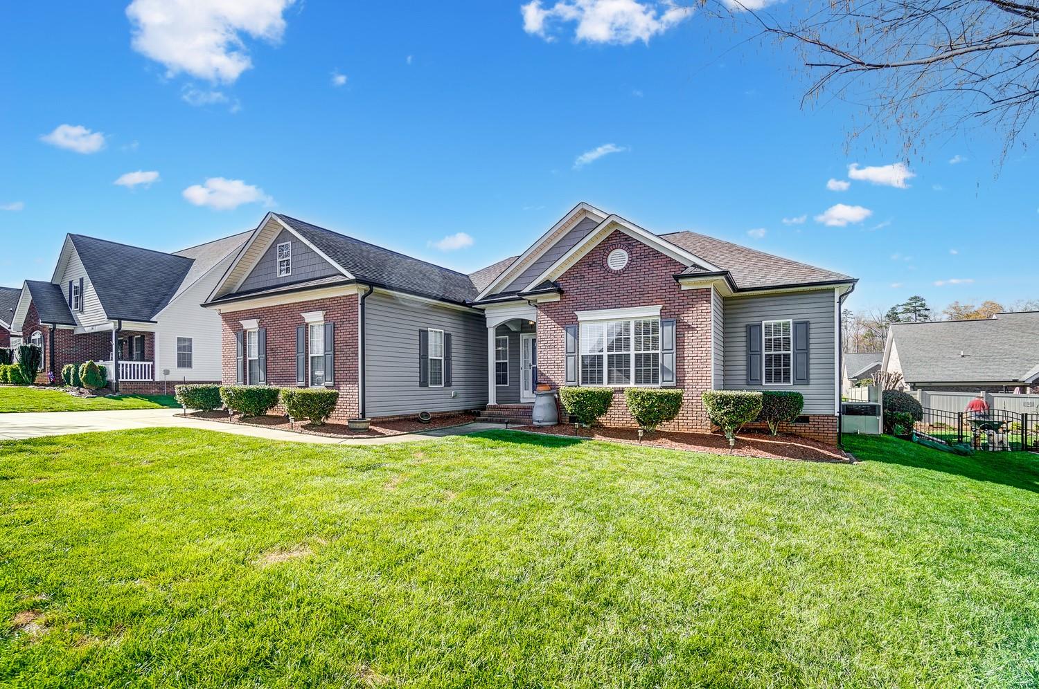 306 Wendover Drive Locust, NC 28097 - Photo 3 of 42 a front view of a house with a yard patio and fire pit