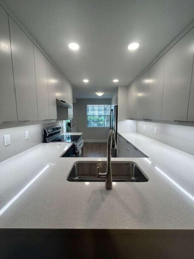 1101 Pinecrest Circle, Unit F Jupiter, FL 33458 - Photo 14 of 18 a view of kitchen with a sink and a large window
