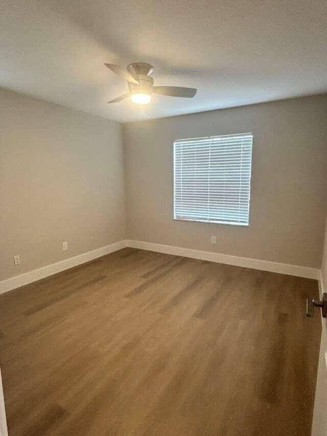 1101 Pinecrest Circle, Unit F Jupiter, FL 33458 - Photo 6 of 18 an empty room with a empty space and a window