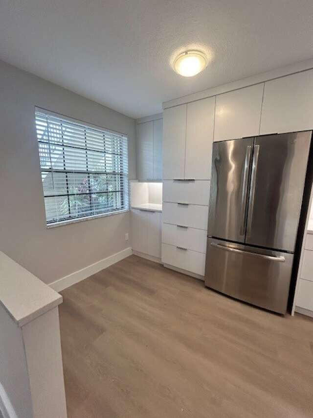 1101 Pinecrest Circle, Unit F Jupiter, FL 33458 - Photo 10 of 18 a kitchen with stainless steel appliances a refrigerator sink and cabinets