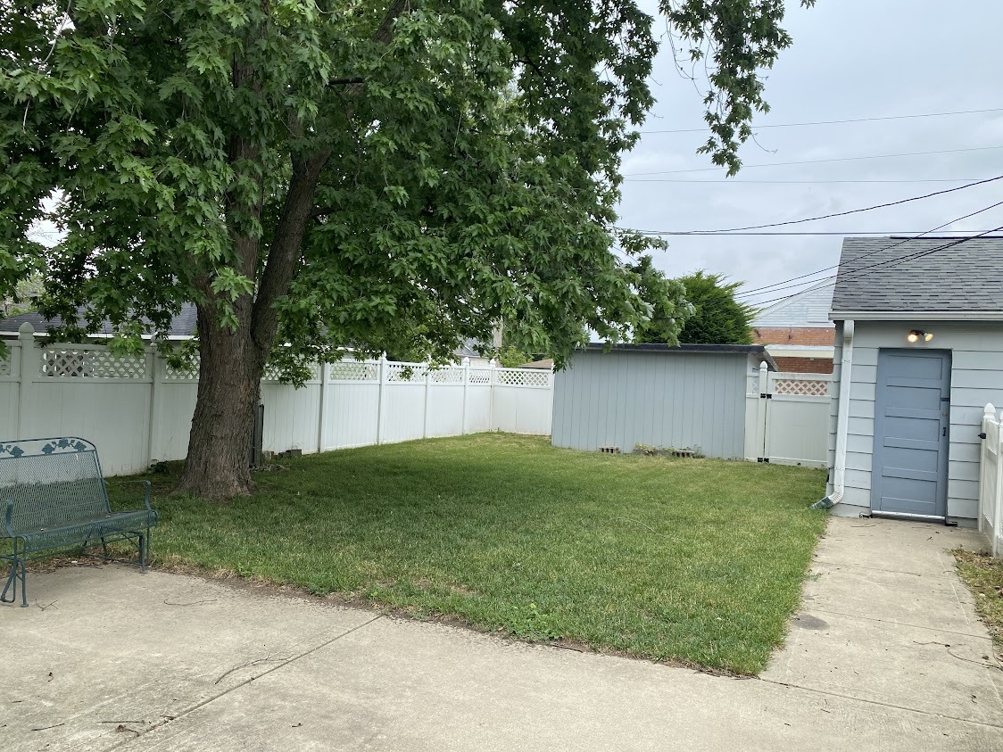 459 West Butterfield Road Elmhurst, IL 60126 - Photo 17 of 17 a view of a backyard with plants and a large tree