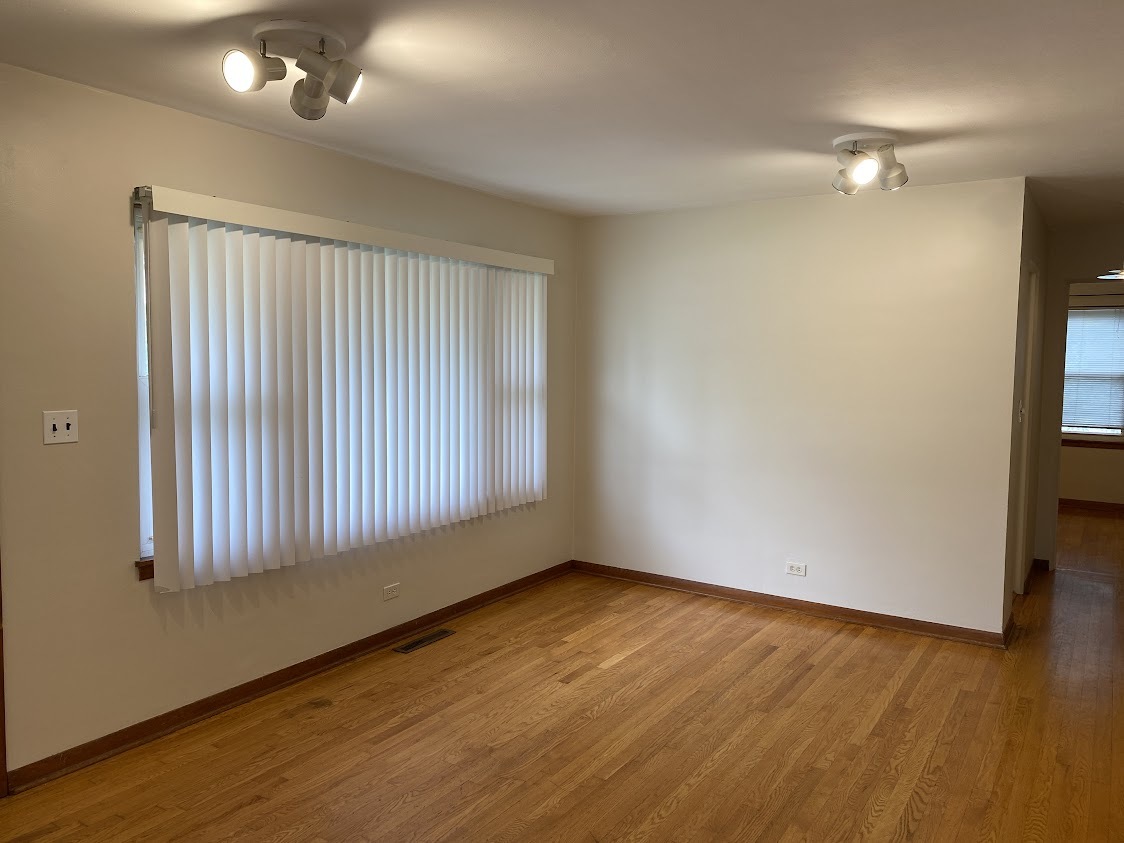 459 West Butterfield Road Elmhurst, IL 60126 - Photo 4 of 17 a view of an empty room with wooden floor and a window