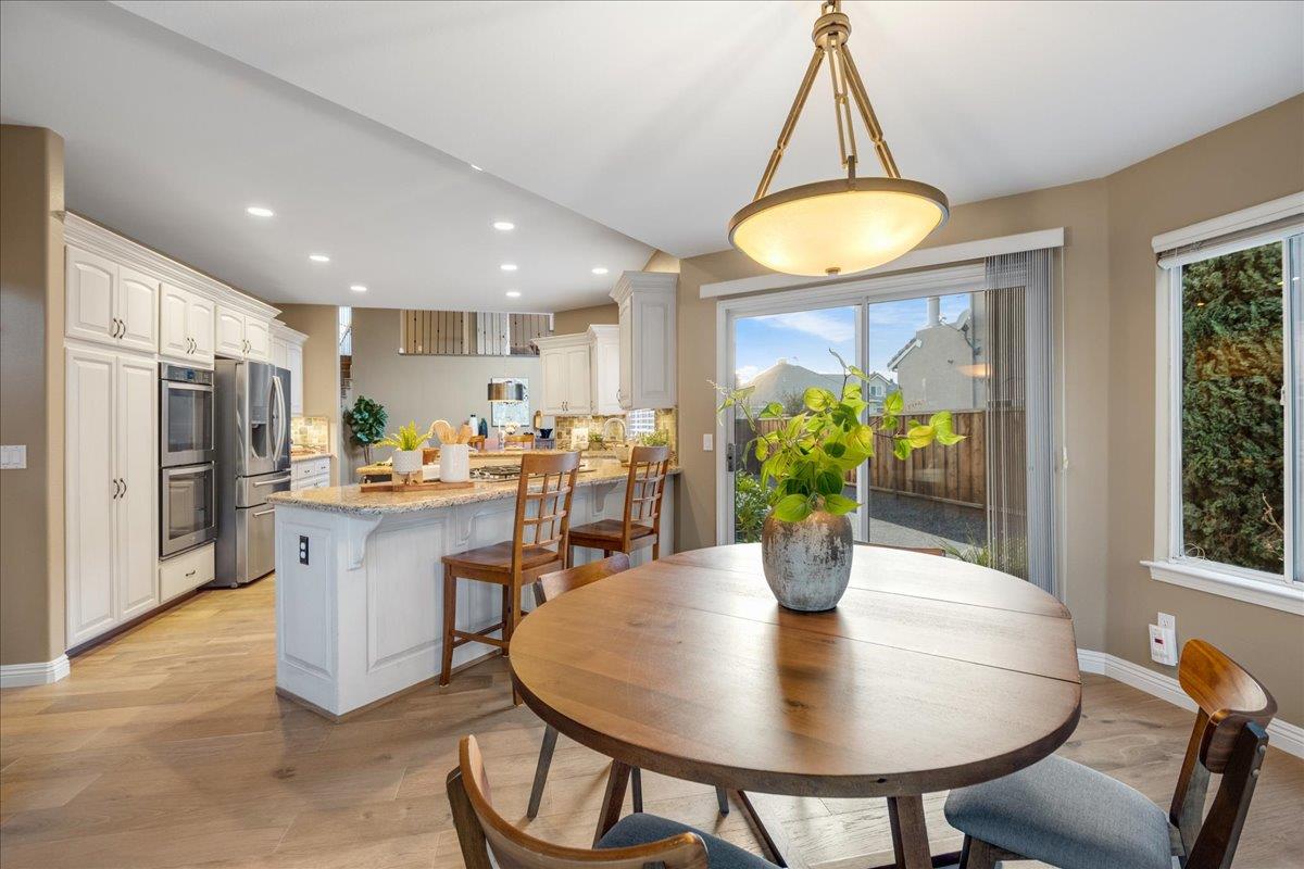 17446 Serene Drive Morgan Hill, CA 95037 - Photo 24 of 82 a kitchen with stainless steel appliances a dining table chairs and chandelier