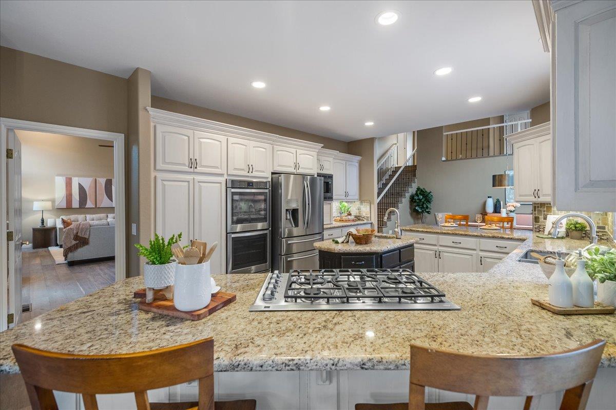 17446 Serene Drive Morgan Hill, CA 95037 - Photo 25 of 82 a kitchen with a table and chairs in it